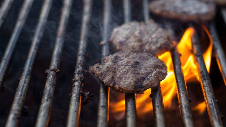 Hamburgers on grill with flare-ups