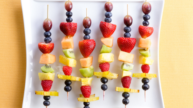 Skewered fruit kabobs on a plate